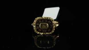 Memorial ring, central locket compartment containing a lock of hair, surrounded by black enamel,