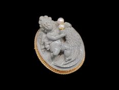 Lava cameo and pearl pendant brooch, lava cameo depicting a cherub with pearl detail, in a yellow