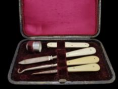 A boxed sewing set, white metal, with bone handles, including a pocket knife and thimble