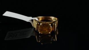 Citrine ring, central oval cut citrine, with textured scroll shoulders, on a wide 9ct yellow gold