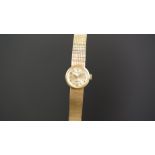 LADIES ROLEX 9K GOLD WRISTWATCH, circular silver dial with gold hour markers, in a 18mm 9k gold case