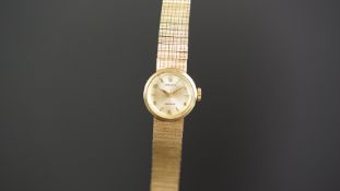 LADIES ROLEX 9K GOLD WRISTWATCH, circular silver dial with gold hour markers, in a 18mm 9k gold case