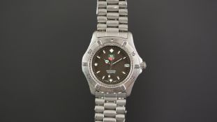 GENTS TAG HEUER PROFESSIONAL WRISTWATCH REF. WE 2110, circular black dial with luminous hour markers