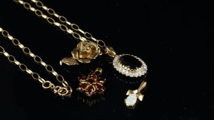 A 9ct yellow gold floral cluster pendant, a 9ct yellow gold opening rose pendant, a yellow metal