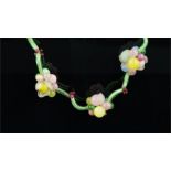 Glass bead necklace, designed as floral clusters, separated by glass tubes