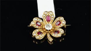 Ruby, diamond and pearl five leaf clover brooch, set with a central old cut diamond and five leaves,
