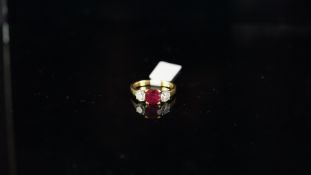 Three stone ruby and diamond ring, central ruby weighing an estimated 1.50ct, with a round brilliant