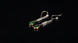 Emerald and diamond drop earrings, each designed as a collet set old cut diamond, suspending a