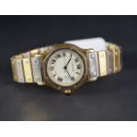 MID SIZE CARTIER 18K GOLD WRISTWATCH, circular beige dial with roman numerals and a date aperture,