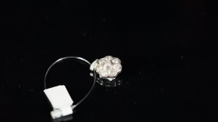 Diamond daisy cluster pendant, eight old cut diamonds, on a diamond set bail, inside pendant