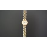 LADIES ROLEX 9K GOLD WRISTWATCH, circular silver dial with gold hour markers, in a 15mm 9k gold case