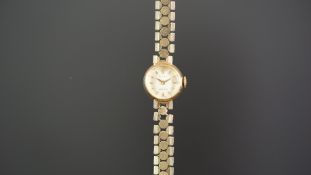 LADIES ROLEX 9K GOLD WRISTWATCH, circular silver dial with gold hour markers, in a 15mm 9k gold case