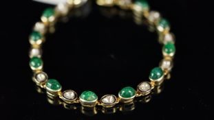 Emerald and diamond bracelet, set with alternating cabochon cut emeralds and polki diamonds,