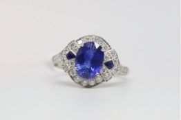 Art Deco style sapphire and diamond ring, oval cut sapphire measuring 9 x 6.5mm, in a round