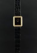 LADIES' DIAMOND SET PIAGET, rectangular black dial with diamond set bezel, 20mm 18ct yellow gold