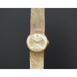 LADIES ROLEX 9K GOLD WRISTWATCH, circular silver dial with gold hour markers, in a 21mm 9k gold case