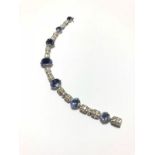 Sapphire and diamond bracelet, seven graduated sugarloaf cabochon cut sapphires, the largest