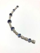 Sapphire and diamond bracelet, seven graduated sugarloaf cabochon cut sapphires, the largest