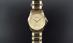 LADIES GUCCI WRISTWATCH REF. 126.5, circular textured gold dial with gold hands and a date aperture,