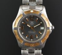 GENTS TAG HEUER PROFESSIONAL REF. WN 1151, circular grey dial with bronze hour markers and a date