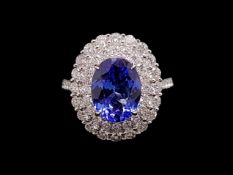 Tanzanite and diamond ring, oval cu tanzanite weighing an estimated 3.36ct, surrounded by two