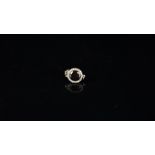 Onyx and diamond clasp, circular faceted onyx, with an old cut diamond surrounded, mounted in