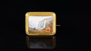 Swiss enamel landscape brooch, depicting mountains and waterfalls in the background and a house