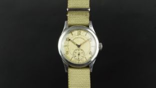 MID SIZE WEST END CO WRISTWATCH, circular aged dial with baton hour markers and Arabic numerals, sub