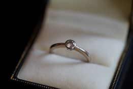 Single stone diamond ring, round brilliant cut diamond, bezel set in 18ct white gold, accompanied by
