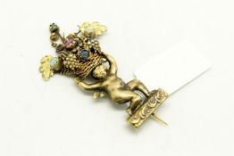 Gem set brooch, depicting a cherub holding a basket of fruit set with a ruby, turquoise and emerald,