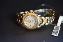 LADIES' BI-COLOUR STAINLESS STEEL/18ct GOLD TAG HEUER QUARTZ DATE WRISTWATCH, REF S99 013L, round