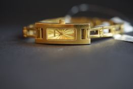 LADIES' GUCCI WRISTWATCH, rectangular gold dial, 12mm gold plated case, original bracelet.