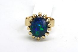 Single stone opal triplet ring, oval cabochon opal triplet, claw set in yellow metal tested as