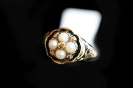 Antique ring, central floral cluster of diamonds and pearls, with a border of black enamel and black