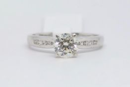 Diamond ring, round brilliant cut diamond weighing an estimated 1.05ct, with channel set round