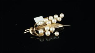 Pearl brooch, designed as leaves and flowers, set with thirteen pearls ranging from 5.2-6mm, mounted