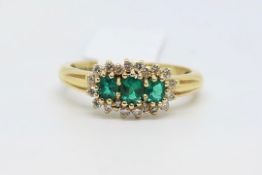 Emerald and diamond cluster ring, three round cut emeralds, surrounded by round brilliant cut