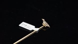 Bird stick pin, rose cut diamond set bird with a ruby eye, set in yellow metal on a yellow metal