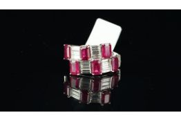 Ruby and diamond cocktail ring, six rectangular cut rubies set with baguette cut diamonds in a cross