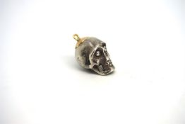 Skull pendant, set with round brilliant cut diamond eyes, weighing an estimated 0.05ct each, set