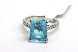 Blue topaz and diamond ring, rectangular mixed cut blue topaz measuring 10.76 x 8.82mm, with round