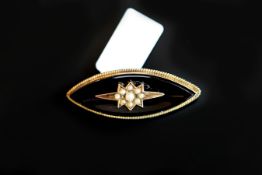 A Victorian mourning brooch, central pearl star, set to the central on the onyx plaque, mounted in