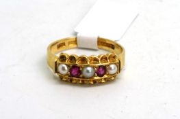 A Victorian ruby and pearl ring, set with three pearls and two rubies, with a scalloped edge,