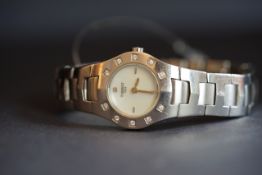 LADIES' STAINLESS STEEL TISSOT QUARTZ WRISTWATCH, REF L521, round mother of pearl dial with silver