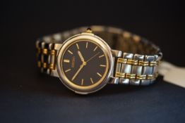 MID SIZE SEIKO WRISTWATCH, circular black dial with gold hour markers and hands, stepped bezel on