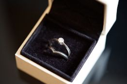 Single stone diamond ring, round brilliant cut diamond weighing an estimated 0.20ct, bezel set in