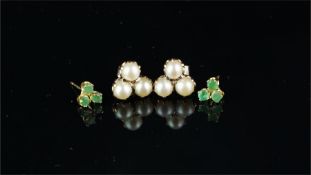 Two pairs of gem set earrings, including a pair set with three emeralds, stamped 14k, post fittings,