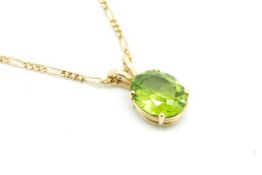 A single stone peridot pendant, oval cut peridot measuring 11.5 x 9.4mm, mounted in 9ct yellow