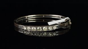 Seven stone diamond bangle, seven graduated old cut diamonds weighing an estimated total of 1.