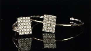 Diamond bangle and ring suite, the torque bangle is set with a rectangular panel of thirty round